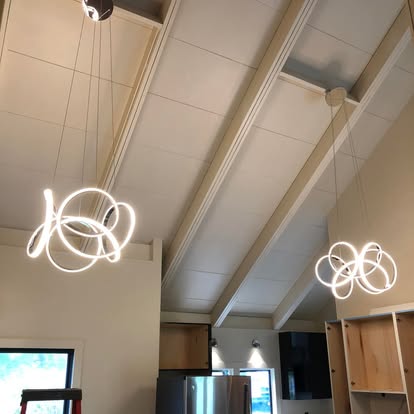 Twin ring pendant light fixtures installed in a kitchen with a vaulted ceiling